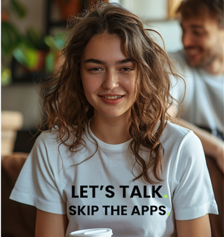 Woman wearing a LET'S TALK. SKIP THE APPS. shirt while a potential connection notices her in the background.